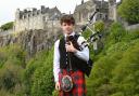 Piper Max Rae pictured fully dressed with Stirling Castle in the backdrop