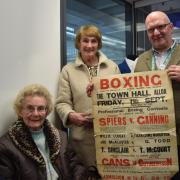 GROWING COLLECTION: Isobel and Jean Speirs deliver more memorabilia relating to Tommy with project officer Ian Mackintosh showcasing a poster advertising a night of bouts at Alloa Town Hall