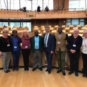 Members of the Dunblane Likhubula Partnership in the debating chamber at Scottish Parliament