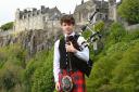Piper Max Rae pictured fully dressed with Stirling Castle in the backdrop