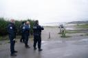 French police look out over a beach near Wimereux in France believed to be used by migrants trying to get to the UK after a boat capsized off the French coast with the loss of 27 lives