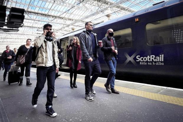 Stirling News: People walking by a Scotrail train. Credit: PA